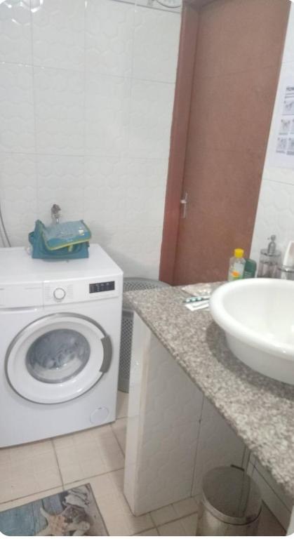 Washing machine beside the bathroom area
