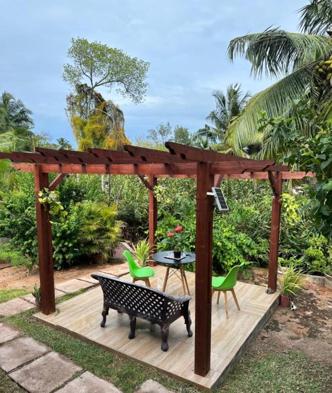 Outdoor dining table beneath a garden pergola