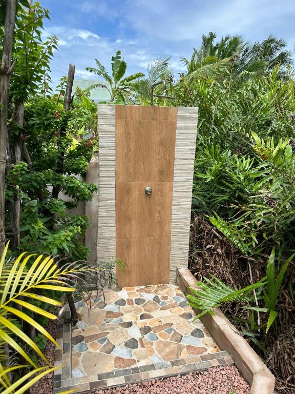 Outdoor shower surrounded by tropical plants
